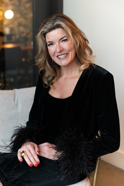 Jennifer Lea, smiling, in a black top.
