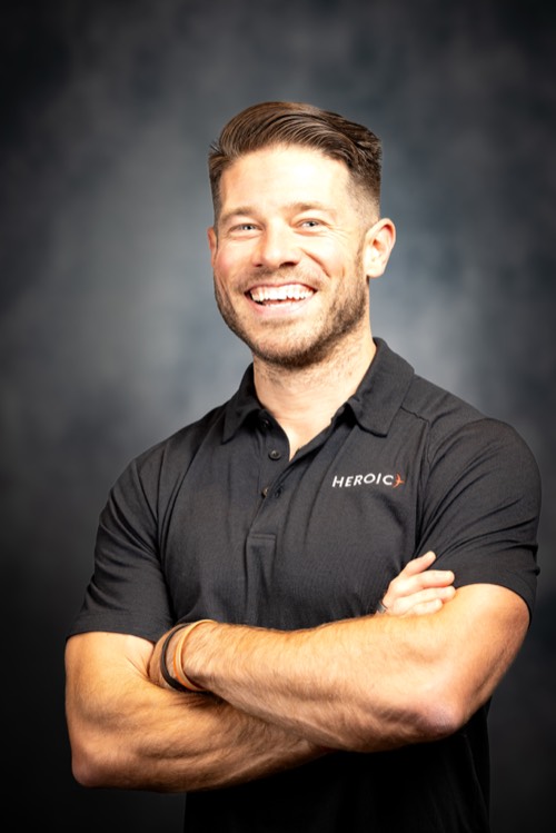 Michael Balchan, arms folded, smiling.